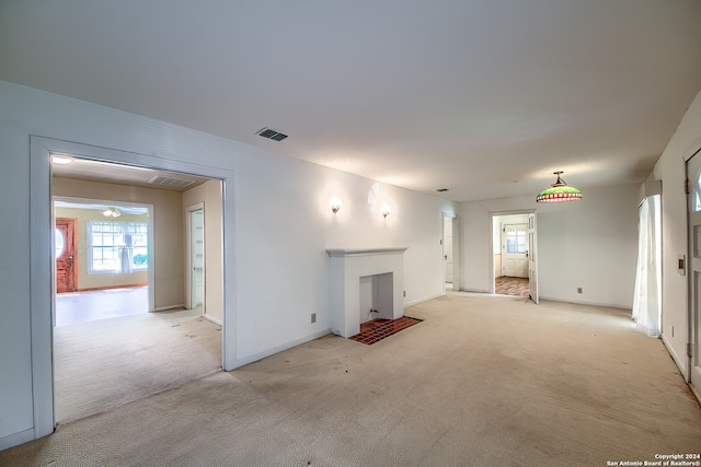 unfurnished living room featuring light colored carpet