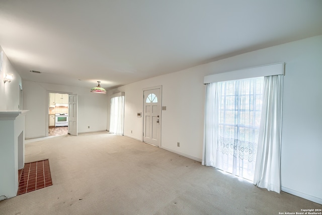 carpeted entryway with a healthy amount of sunlight