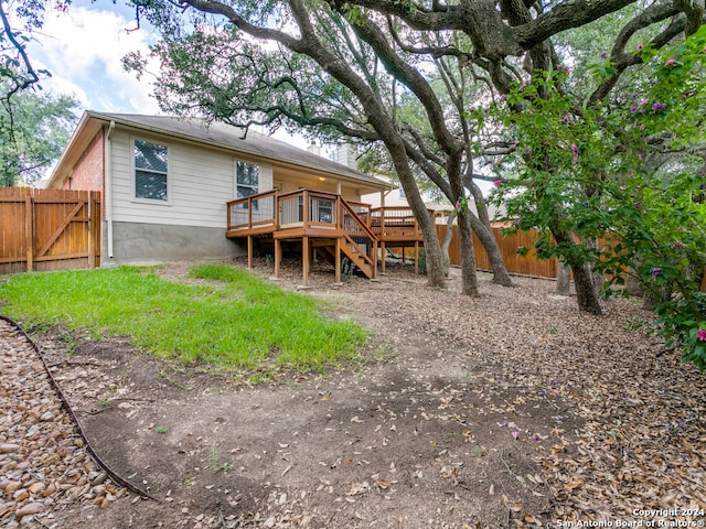 back of property featuring a wooden deck