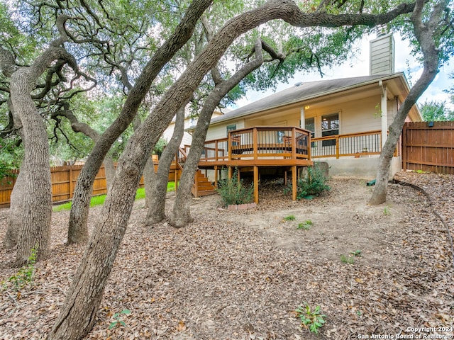 rear view of house featuring a deck