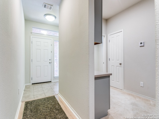 corridor featuring light colored carpet