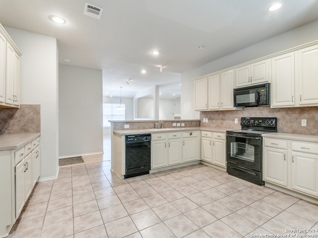 kitchen with black appliances, kitchen peninsula, light tile patterned floors, and backsplash