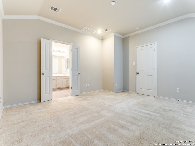 spare room with light carpet, lofted ceiling, and crown molding