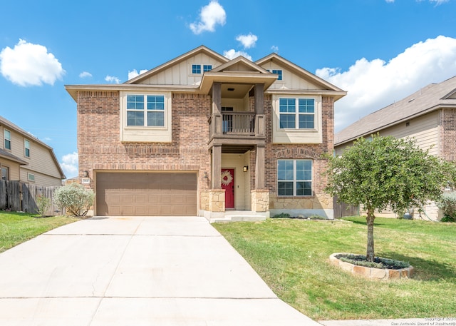 view of front of property with a balcony, a front lawn, and a garage