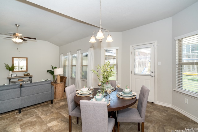 dining room with ceiling fan with notable chandelier, lofted ceiling, and a wealth of natural light