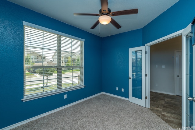 unfurnished bedroom with ceiling fan and carpet flooring