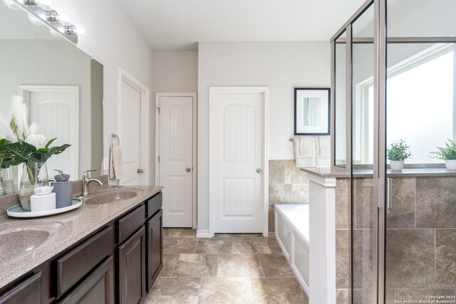 bathroom featuring vanity and a tub