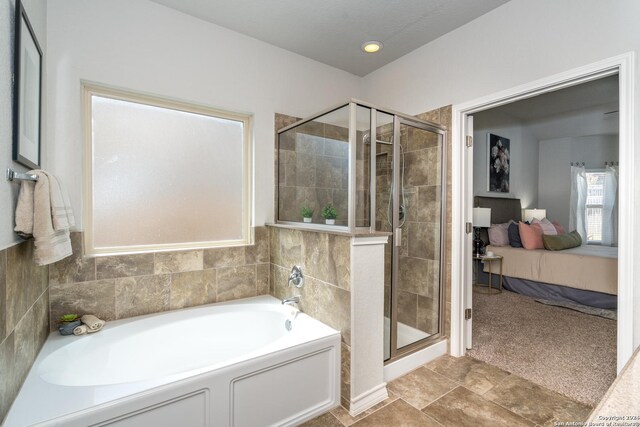 bathroom featuring shower with separate bathtub and tile patterned floors