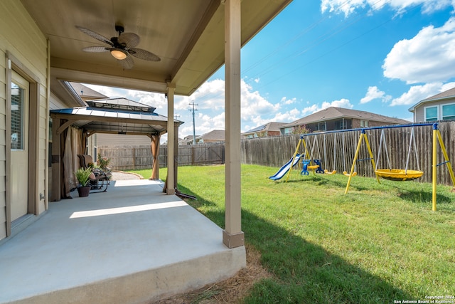 view of yard with a playground, a gazebo, ceiling fan, and a patio area