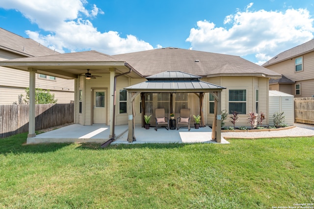 back of property featuring a gazebo, a yard, and a patio