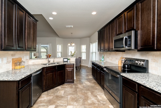 kitchen featuring stainless steel appliances, backsplash, a healthy amount of sunlight, and sink