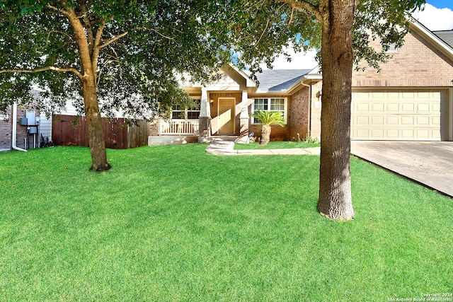 single story home featuring a garage, covered porch, and a front lawn