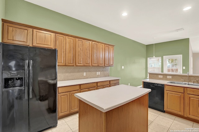 kitchen featuring a center island, light tile patterned flooring, sink, backsplash, and black appliances