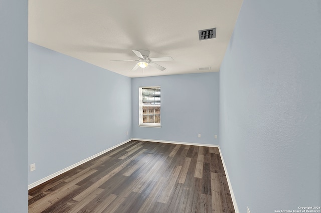 unfurnished room with ceiling fan and dark hardwood / wood-style flooring