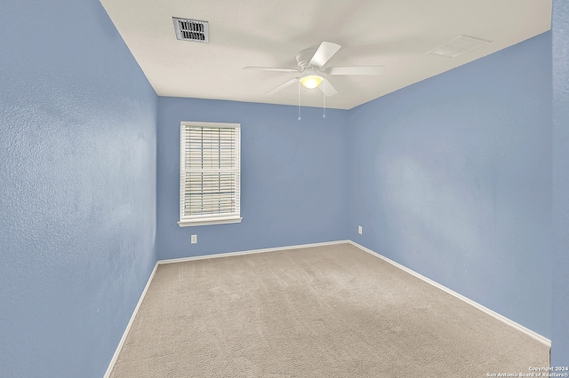 empty room with ceiling fan and carpet floors