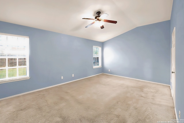 unfurnished room featuring ceiling fan, lofted ceiling, and carpet flooring