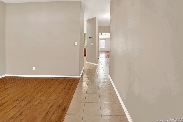 hallway with light hardwood / wood-style floors