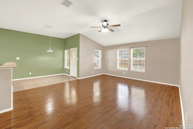 spare room featuring wood-type flooring, lofted ceiling, and ceiling fan