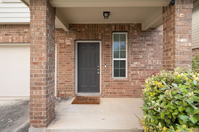 property entrance with brick siding