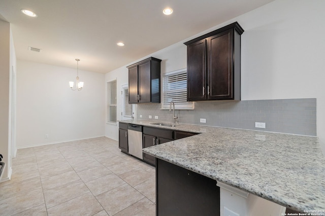 kitchen with light stone countertops, a sink, stainless steel dishwasher, decorative backsplash, and pendant lighting