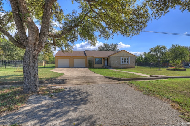 single story home with a garage and a front lawn