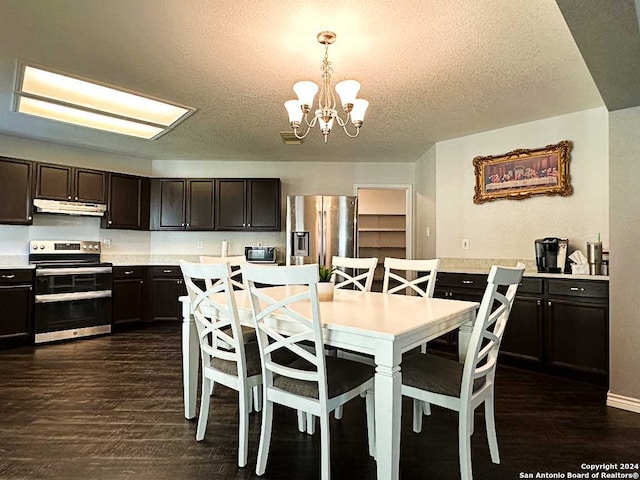 dining room with a chandelier, a textured ceiling, and dark wood-type flooring