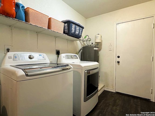 washroom featuring washer and clothes dryer, water heater, and dark hardwood / wood-style floors