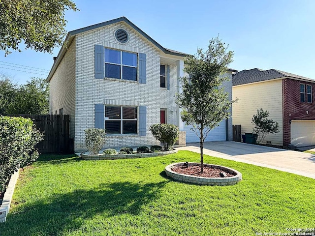 view of front property with a garage and a front yard