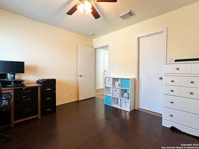 office space featuring a textured ceiling, dark hardwood / wood-style floors, and ceiling fan