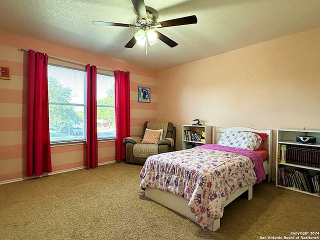 bedroom featuring carpet floors, a textured ceiling, and ceiling fan