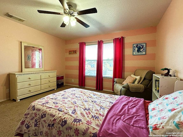 carpeted bedroom with a textured ceiling and ceiling fan