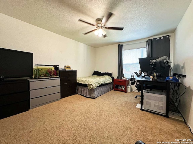 carpeted bedroom with ceiling fan and a textured ceiling