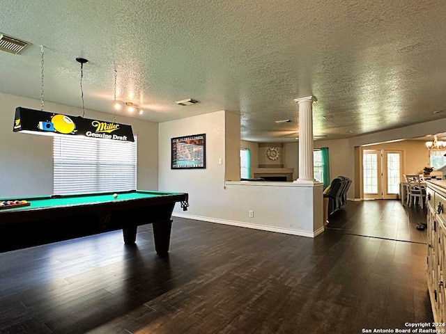 recreation room with a textured ceiling, decorative columns, dark hardwood / wood-style floors, and billiards