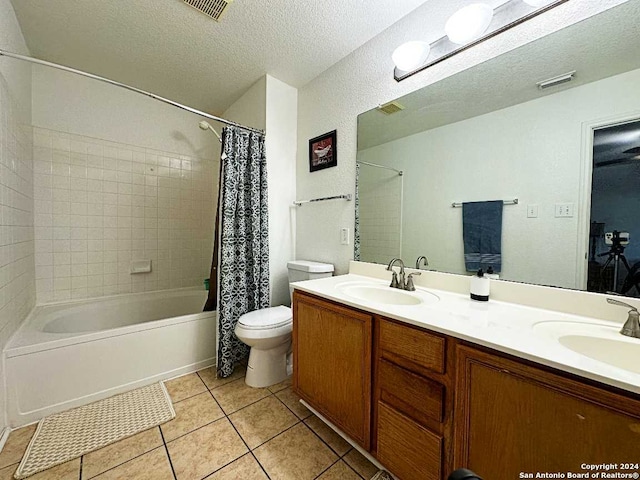 full bathroom with a textured ceiling, shower / bathtub combination with curtain, toilet, and vanity