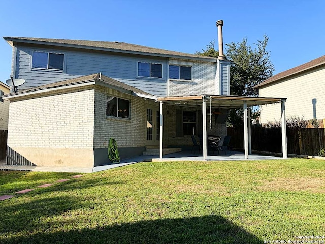 back of house with a lawn and a patio area