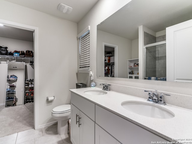 bathroom featuring vanity, tile patterned floors, an enclosed shower, and toilet