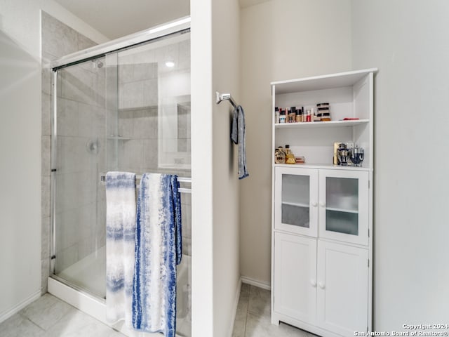 bathroom with a shower with door