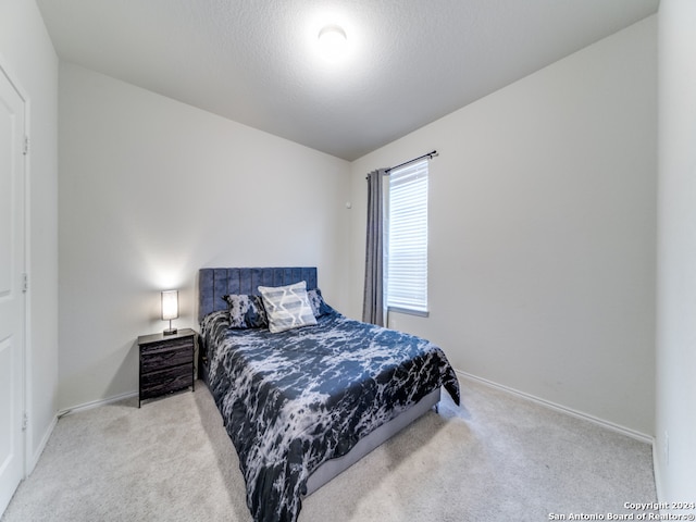 bedroom featuring light carpet