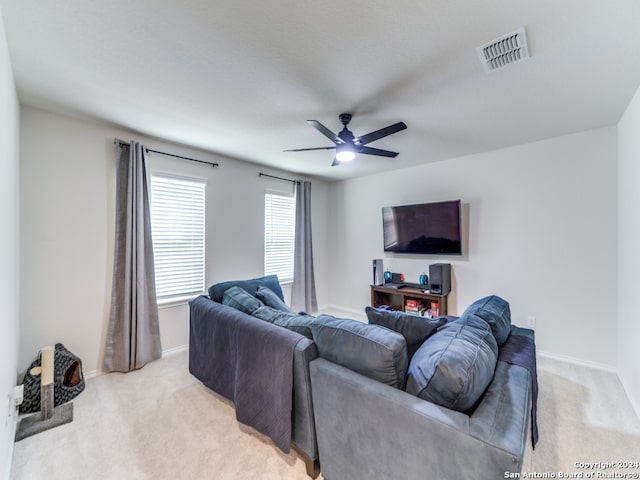 carpeted living room with ceiling fan