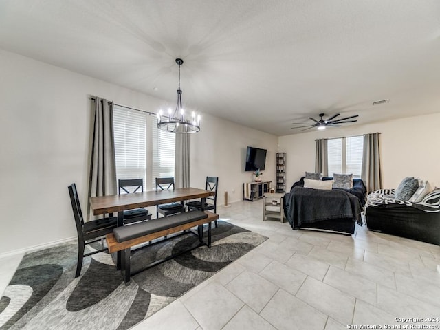 dining area with visible vents, light tile patterned floors, and ceiling fan with notable chandelier