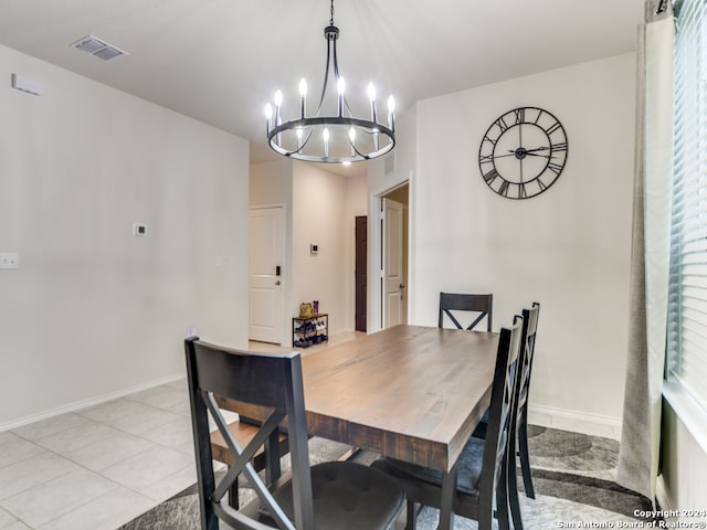 dining area featuring light tile patterned floors and a chandelier