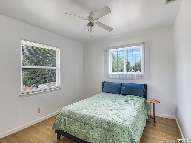 bedroom with ceiling fan and hardwood / wood-style floors