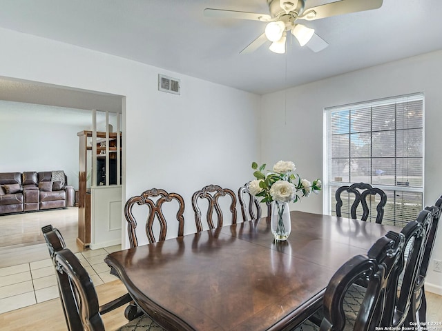 dining area featuring light tile patterned floors and ceiling fan