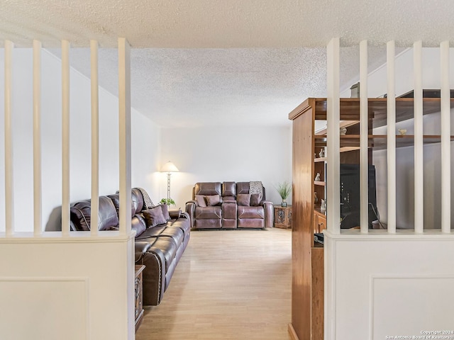 living room featuring a textured ceiling and hardwood / wood-style floors