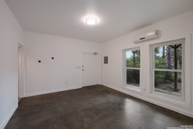 spare room with electric panel and a wall mounted air conditioner