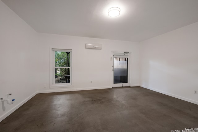 unfurnished room with a wall mounted AC