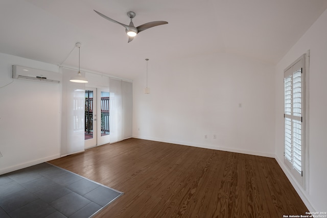 unfurnished room featuring dark wood-type flooring, ceiling fan, a wall mounted air conditioner, and a wealth of natural light