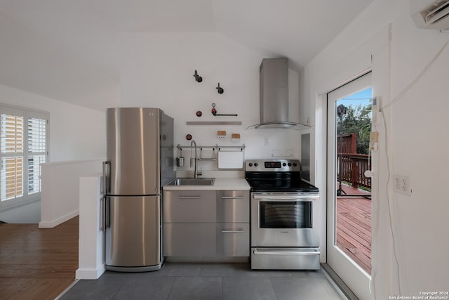 kitchen featuring stainless steel appliances, plenty of natural light, sink, and wall chimney range hood