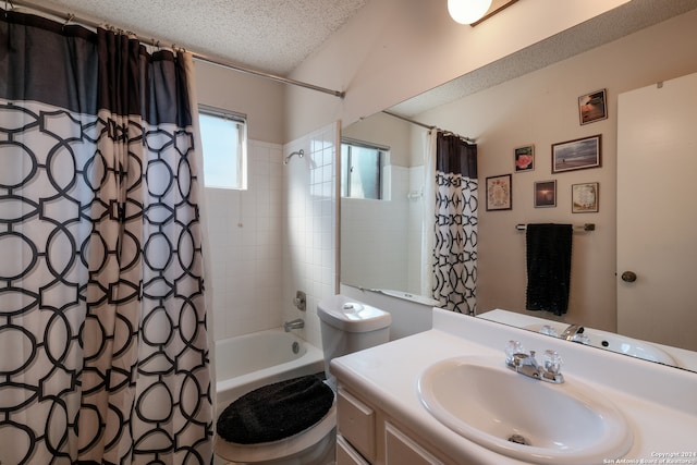 full bathroom featuring a textured ceiling, vanity, toilet, and shower / bath combination with curtain