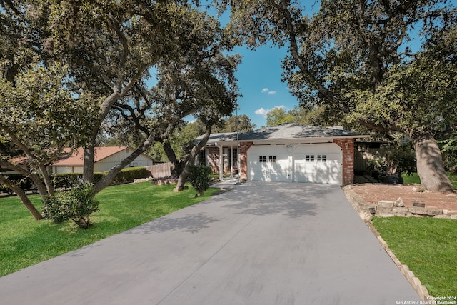 ranch-style house featuring a front yard and a garage